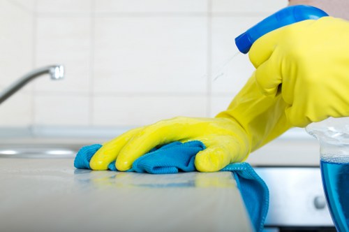 Cleaner wearing PPE while handling cleaning equipment
